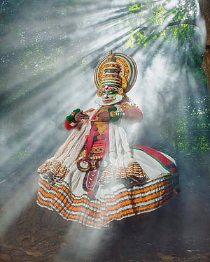 Kathakali Dancer in Elaborate Traditional Costume Performing in Misty Forest Setting HD phone wallpaper