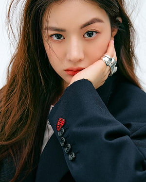 Portrait of Korean actress Kim Ji-won wearing a navy blazer with red embroidery and silver rings HD phone wallpaper
