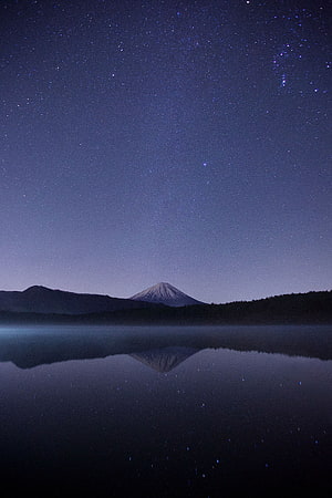 Mount Fuji Silhouette Reflected in Calm Lake Under a Starry Night Sky HD phone wallpaper