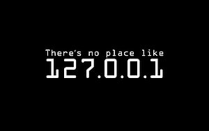 Minimalist Black Background with White Monospace Text Reading There's No Place Like 127.0.0.1 HD wallpaper