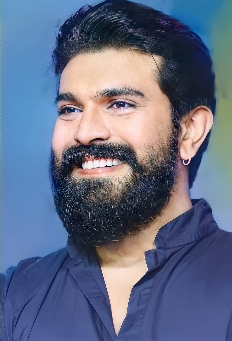 Ram Charan smiling portrait with full beard and dark shirt against blue background HD phone wallpaper