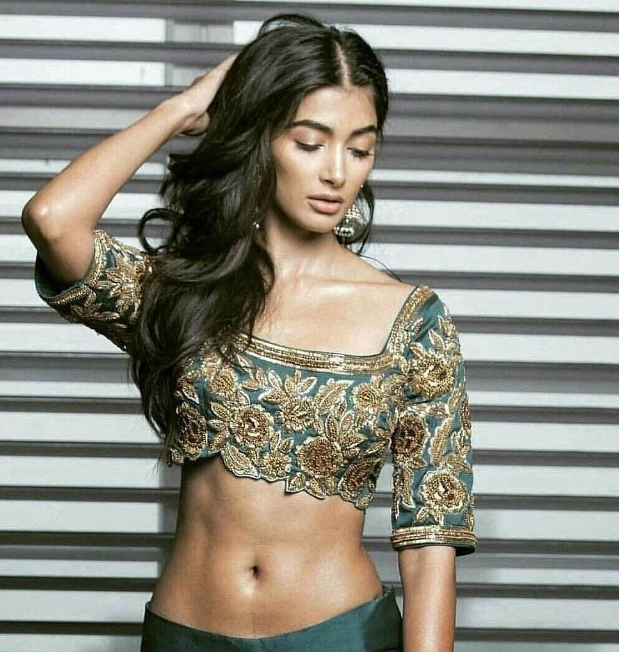 Pooja Hegde in an elegant green and gold embroidered crop top with a scalloped hem, posing against a striped background HD phone wallpaper