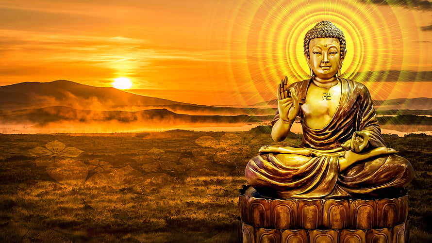 Golden Buddha Statue Meditating at Sunset with Radiant Halo and Mountain Landscape HD wallpaper