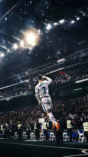 Cristiano Ronaldo jumping celebration in white jersey at stadium HD phone wallpaper