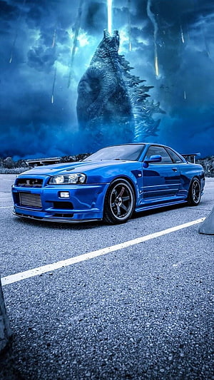 Blue Nissan Skyline GT-R R34 with Godzilla in Background HD phone wallpaper