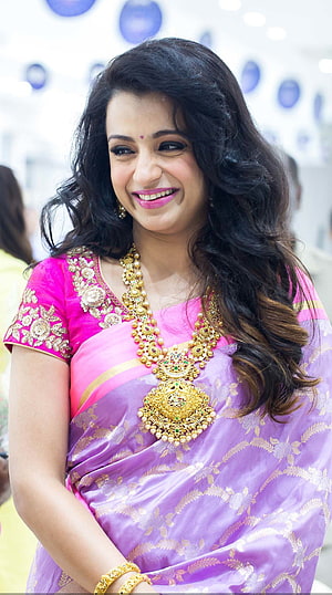 Trisha Krishnan in a purple and pink saree with ornate gold jewelry HD phone wallpaper