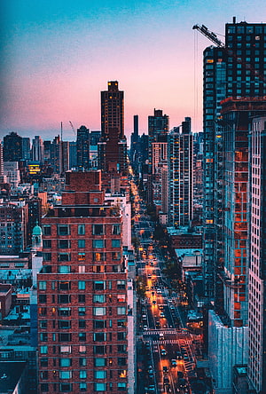 New York City Skyline at Dusk with Glowing Streetlights and Brick Architecture HD phone wallpaper