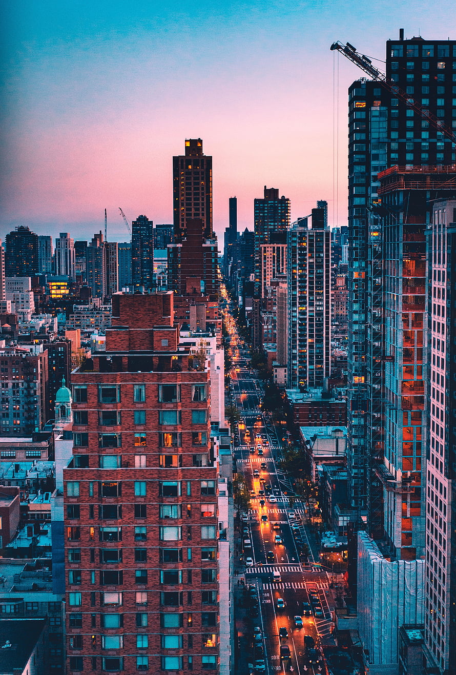 New York City Skyline at Dusk with Glowing Streetlights and Brick Architecture HD phone wallpaper