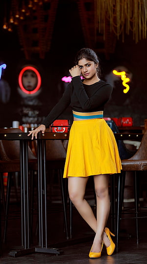 Sanjana Anand in Black Top and Yellow Skirt at Neon-Lit Cafe HD phone wallpaper