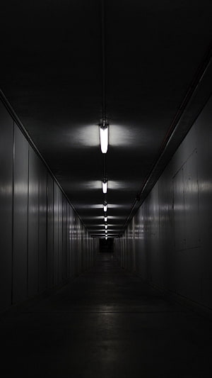 Eerie Dimly Lit Industrial Corridor with Fluorescent Ceiling Lights HD phone wallpaper
