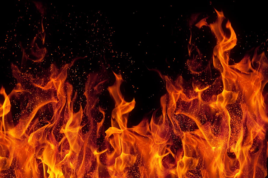 Intense Orange Flames and Glowing Embers Rising Against a Pitch Black Background HD wallpaper