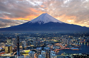 Mount Fuji Rising Over Osaka City Skyline at Sunset HD wallpaper