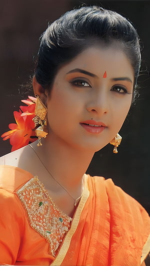 Portrait of a woman in traditional Indian attire wearing an orange saree, gold jewelry, and flowers in her hair, Divya Bharti, bollywood actress HD phone wallpaper