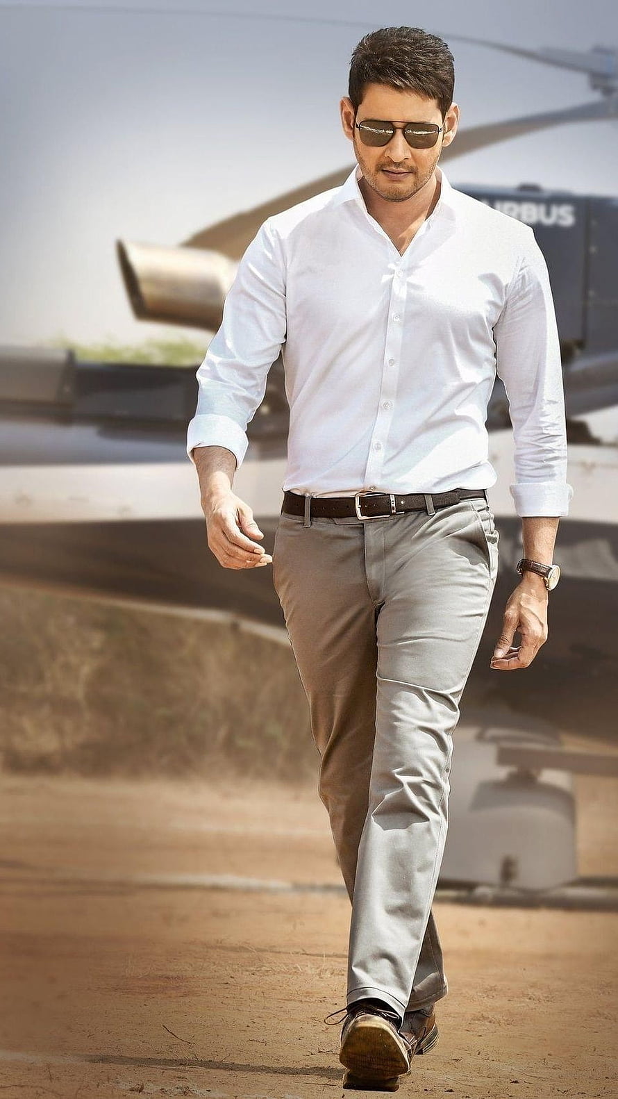Mahesh Babu Walking In White Shirt And Grey Trousers With Helicopter Background HD phone wallpaper