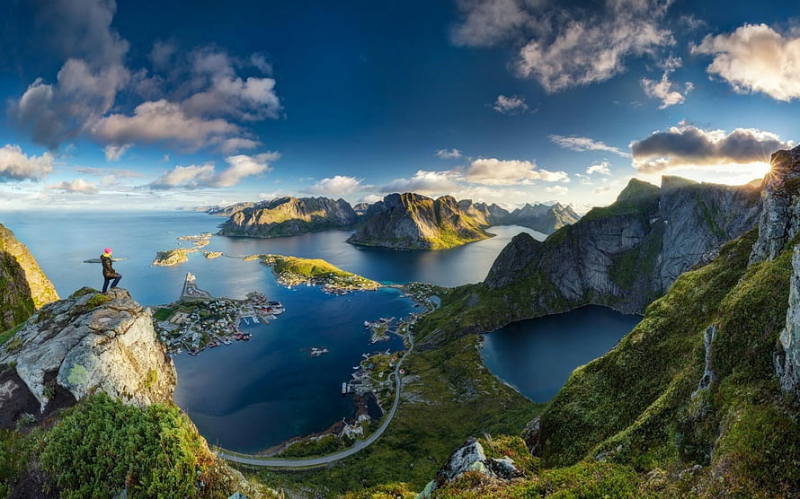 Dramatic Fjord Panorama with Hiker on Rocky Cliff and Scattered Islands HD wallpaper