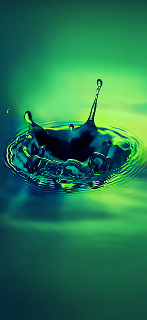 Vibrant Green Water Droplet Splash with Dynamic Ripples and Crown Formation HD phone wallpaper