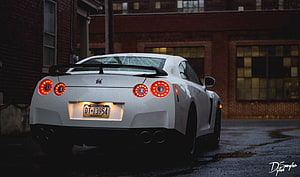 White Nissan GT-R Rear View with Glowing Taillights Parked on Wet Urban Street at Dusk HD wallpaper