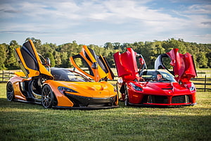 McLaren P1 and Ferrari LaFerrari Hypercars with Butterfly Doors Open on Grass Field HD wallpaper