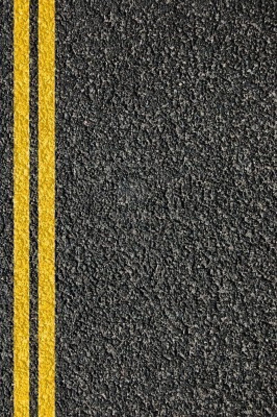 Close-up of dark asphalt road surface with double yellow center lines HD phone wallpaper