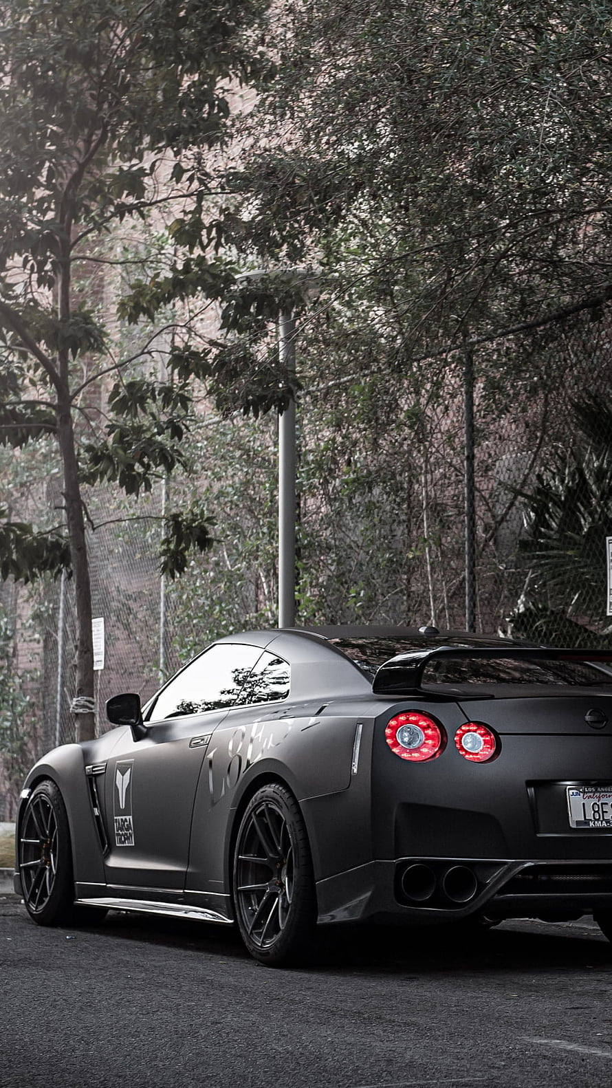 Matte Black Nissan GT-R R35 Rear Three-Quarter View with Taiga Decal and Dual Exhausts HD phone wallpaper