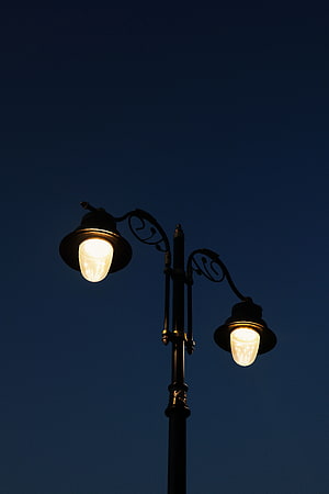 Ornate Double Street Lamp Glowing Against Deep Blue Night Sky HD phone wallpaper