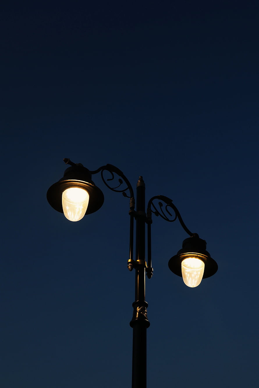 Ornate Double Street Lamp Glowing Against Deep Blue Night Sky HD phone wallpaper
