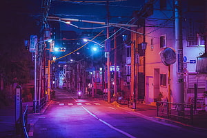 Neon-lit Japanese street at night with purple and blue cinematic lighting HD wallpaper