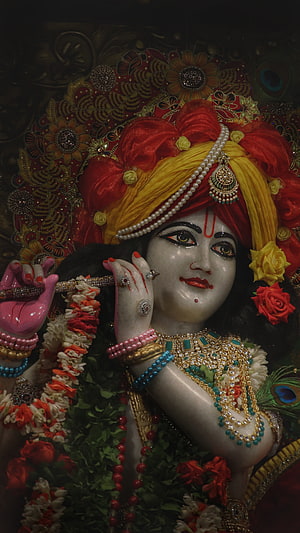 Ornate Krishna Murti with Flute, Marigold Garland, and Traditional Jewelry HD phone wallpaper