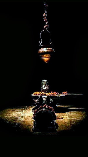 Shiva Lingam with Sacred Thread and Hanging Brass Lamp in Dark Atmosphere HD phone wallpaper