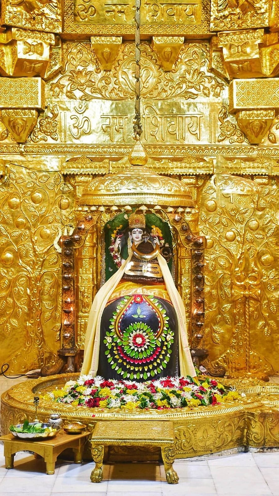 Somnath Mahadev Temple Shiva Lingam with Ornate Gold Carvings and Floral Offerings HD phone wallpaper