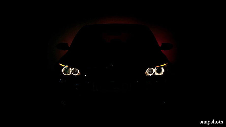Mysterious Car Silhouette with Glowing Angel Eye Headlights in the Dark HD wallpaper