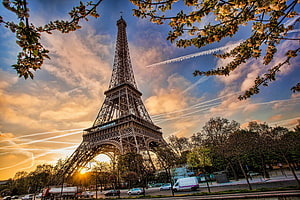 Eiffel Tower at Sunset with Cherry Blossoms and Contrails HD wallpaper