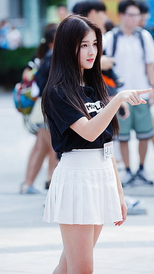 Nancy from Momoland pointing in a black t-shirt and white pleated skirt HD phone wallpaper
