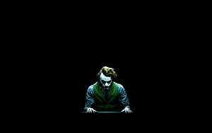 Joker Character in Green Vest Leaning Forward Against Pitch Black Background HD wallpaper