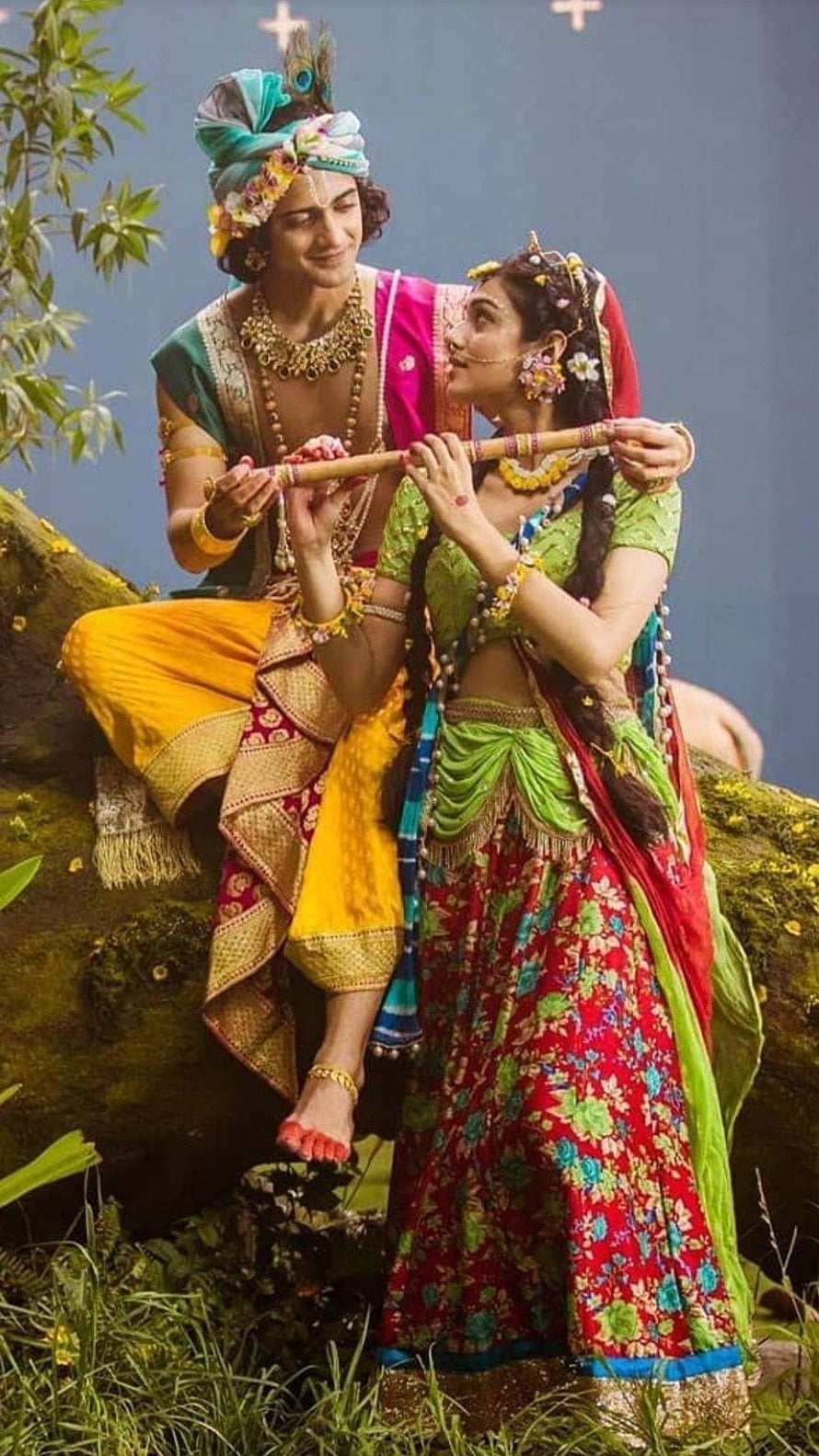 Radha and Krishna Playing Flute Together in Traditional Attire HD phone wallpaper