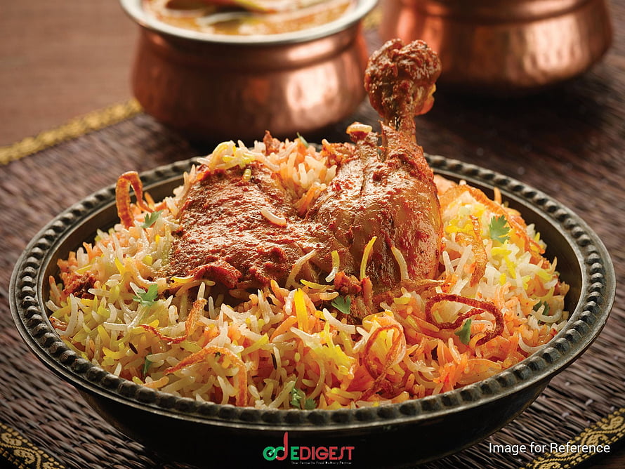 Hyderabadi Chicken Biryani with Saffron Rice and Crispy Onions in a Traditional Metal Bowl HD wallpaper