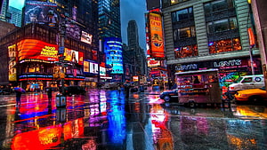 Vibrant Time Square New York City at Night with Rainy Street Reflections HD wallpaper