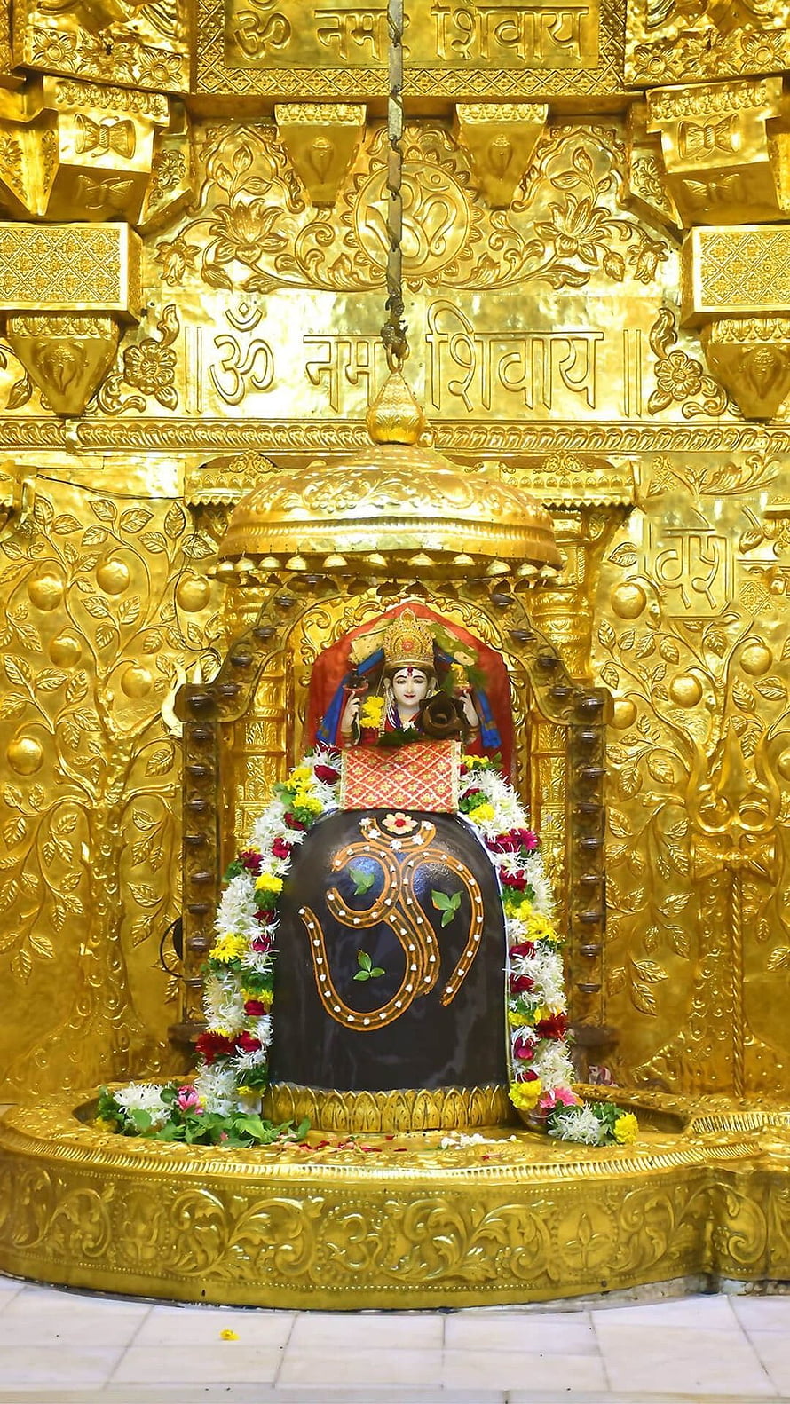 Golden Shiva Lingam Temple Altar with Om Symbol and Floral Garlands HD phone wallpaper