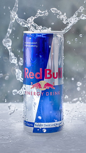 Red Bull Energy Drink Can with Dynamic Water Splash and Condensation Droplets HD phone wallpaper
