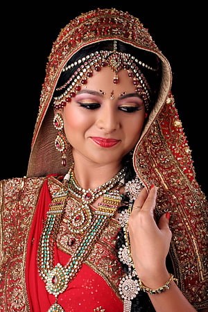 Elegant Indian Bride in Red Lehenga with Heavy Gold Jewelry and Traditional Bridal Makeup HD phone wallpaper