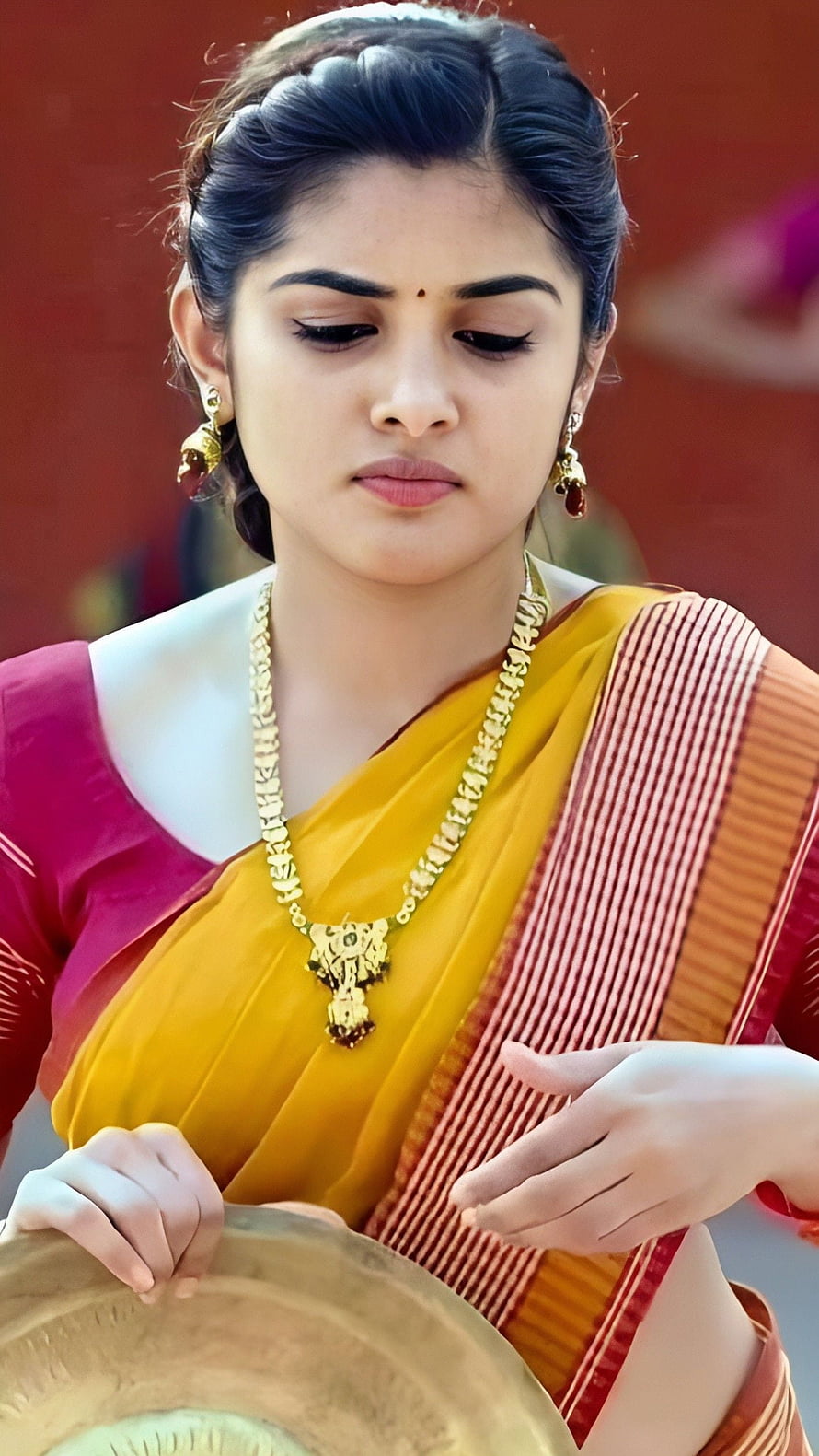 Nivetha Thomas in Traditional Yellow Saree with Gold Jewelry and Brass Plate HD phone wallpaper
