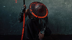 Cyberpunk Monk with Glowing Red Hat and Staff in Dark Room HD wallpaper