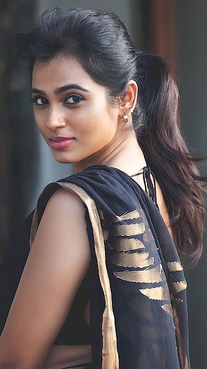 Ramya Pandian in a black and gold saree with a high ponytail and elegant makeup HD phone wallpaper