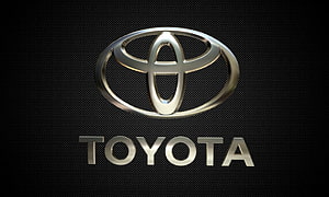 Sleek Silver Toyota Emblem on Dark Textured Background HD wallpaper