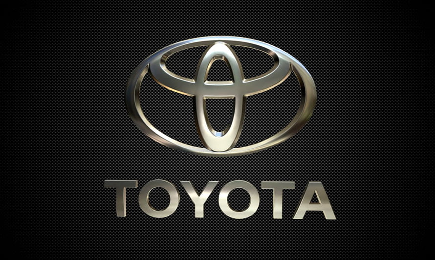 Sleek Silver Toyota Emblem on Dark Textured Background HD wallpaper