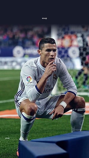 Cristiano Ronaldo in Real Madrid Kit Crouching on the Pitch During a La Liga Match HD phone wallpaper