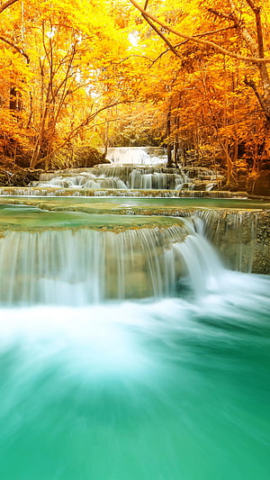 Turquoise Tiered Waterfall Cascading Through Vibrant Golden Autumn Forest HD phone wallpaper