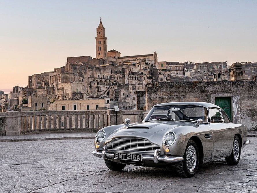 Silver Aston Martin DB5 Classic Car Parked in Matera Italy at Sunset HD wallpaper