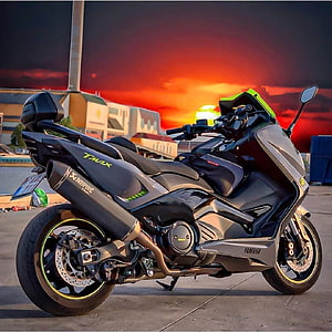 Yamaha TMax 530 Max-Scooter Parked Against a Dramatic Sunset Sky HD phone wallpaper