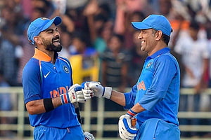 Virat Kohli and MS Dhoni Celebrate in Indian Cricket Blue ODI Uniforms HD wallpaper